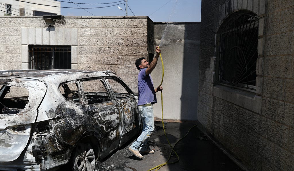 resident dousing burned out property